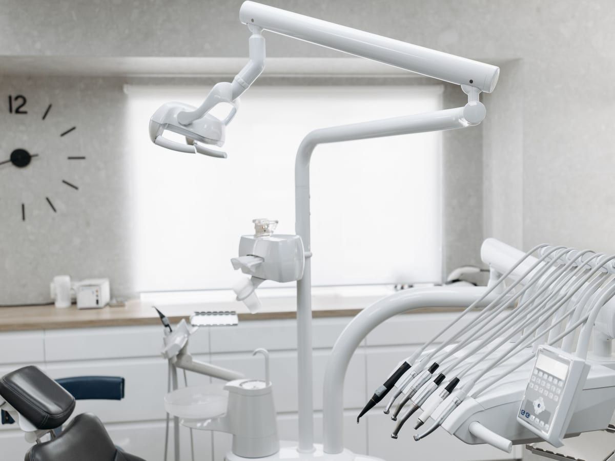 The overhead light and instruments beside a dental chair